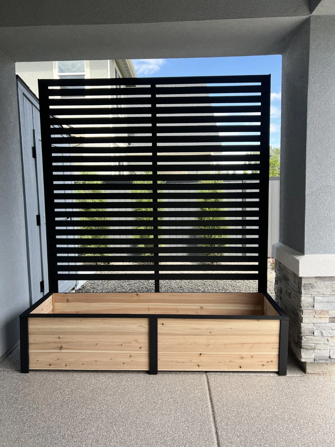 Custom cedar privacy planter installed in its final covered-patio location