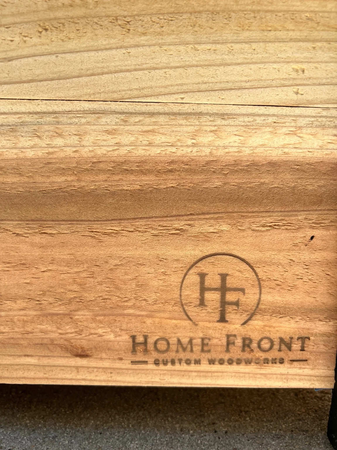 Home Front Custom Woodworks brand mark burned into the cedar planter